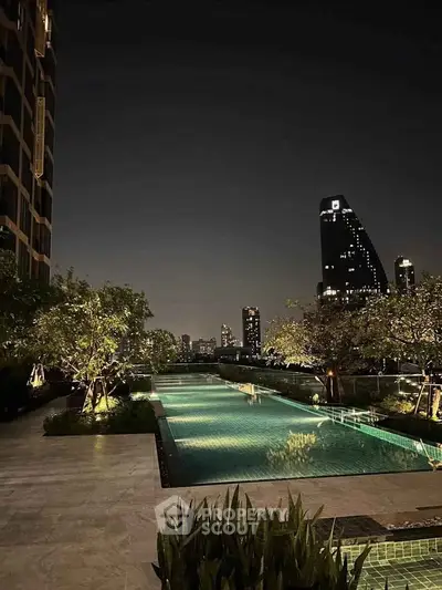 Luxurious rooftop pool with stunning city skyline view at night, perfect for relaxation and entertainment.