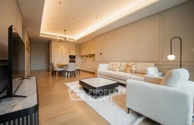 Luxurious modern living room with open kitchen, elegant decor, and cozy seating area.