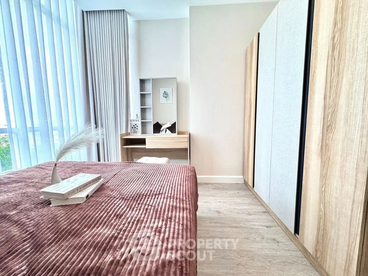Modern bedroom with stylish decor and ample natural light