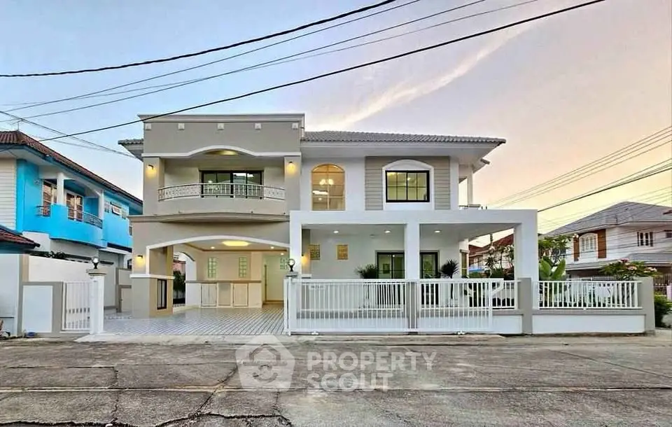 Stunning modern two-story house with spacious balcony and elegant facade in a serene neighborhood.