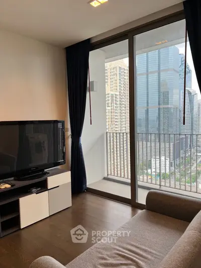 Modern living room with city view and large windows in high-rise apartment.