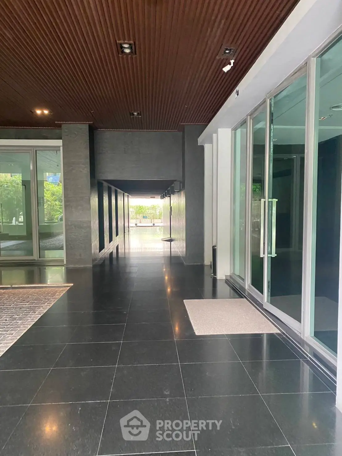 Modern building entrance with sleek glass doors and polished flooring