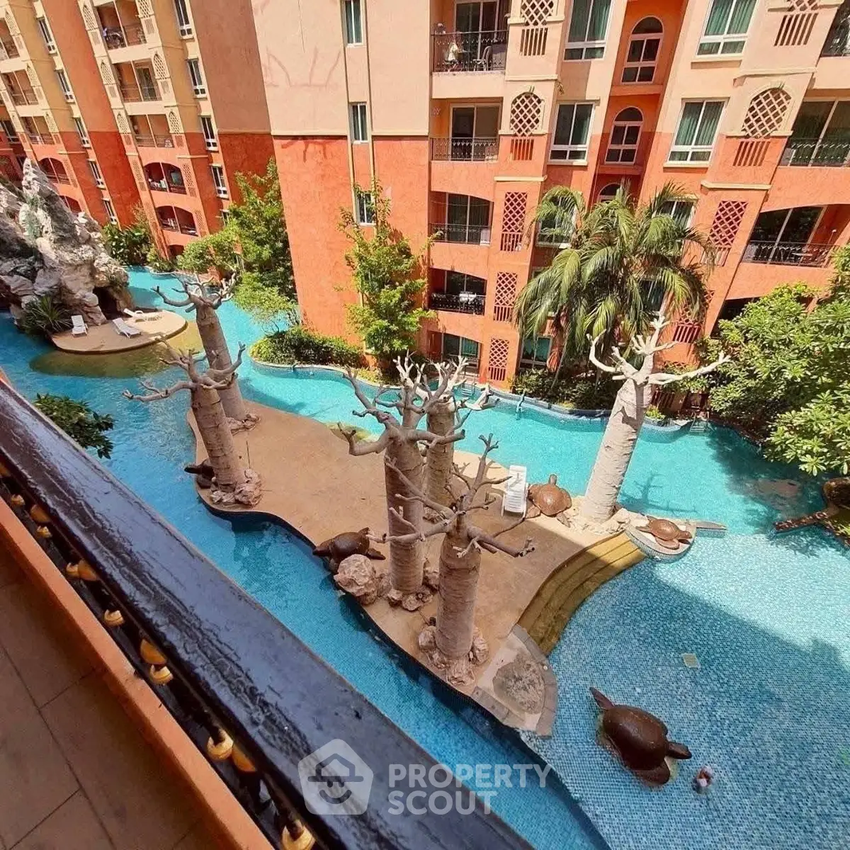 Stunning view of a unique pool area with artistic sculptures and lush greenery.