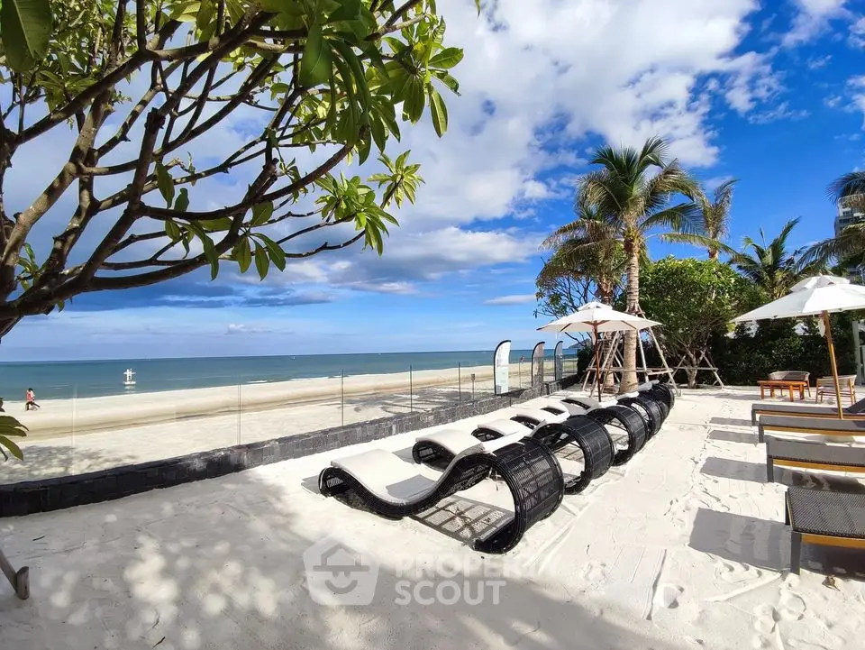Luxurious beachfront property with stunning ocean views and relaxing lounge area.