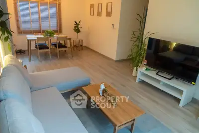 Modern living room with stylish furniture and natural light, perfect for relaxation and entertainment.