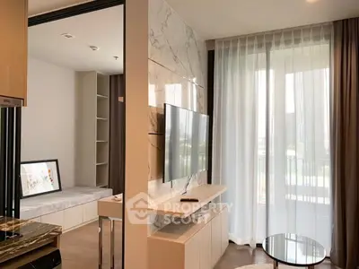 Modern living room with marble accent wall and large window offering natural light