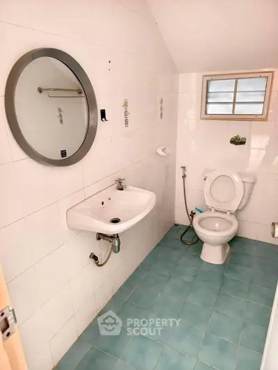 Compact bathroom with modern fixtures and blue tile flooring