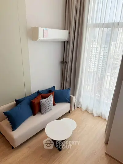 Modern living room with stylish sofa and city view through large window