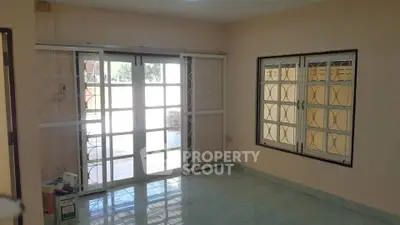 Spacious empty room with large windows and tiled floor, perfect for customization.