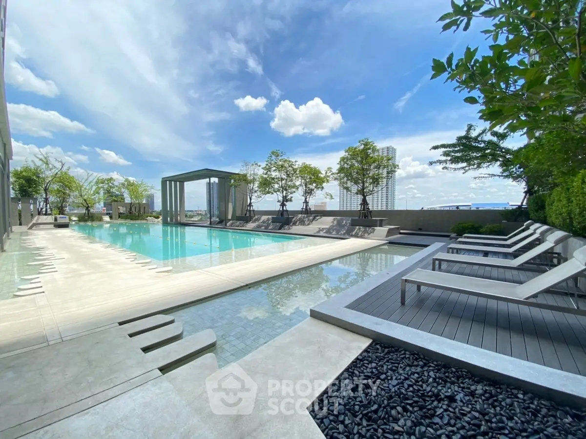 Luxurious rooftop pool with stunning city views and modern lounge area.