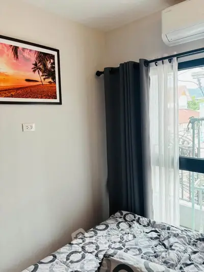 Cozy bedroom with modern decor and balcony view, perfect for relaxation.