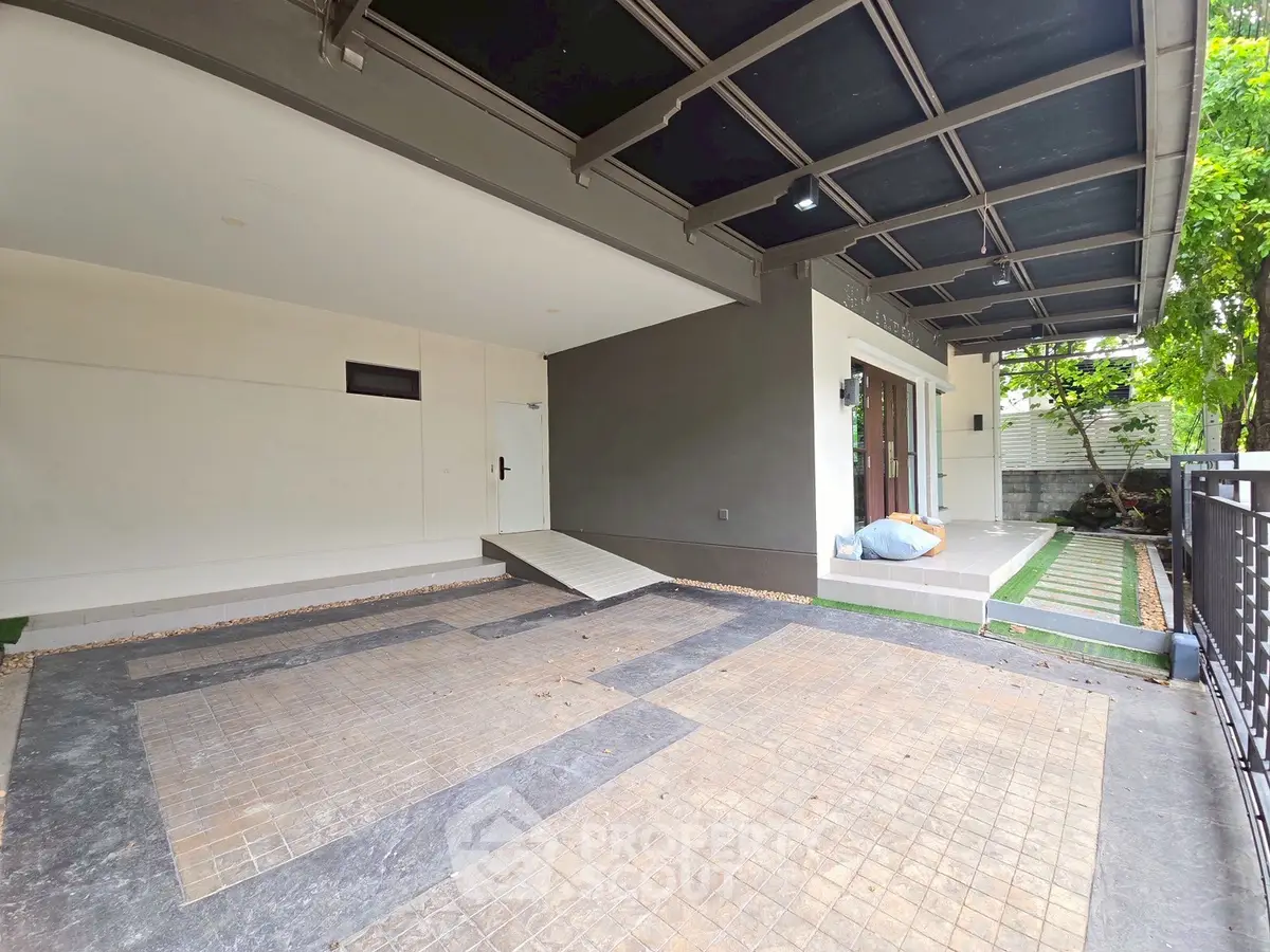Modern home entrance with spacious driveway and sleek design