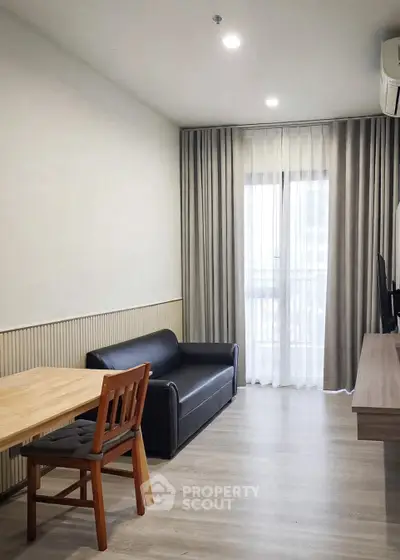 Modern living room with sleek furniture and natural light, perfect for urban living.