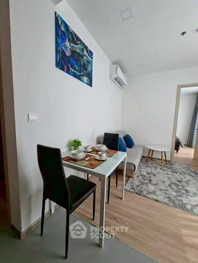 Modern living room with dining area and stylish decor in a cozy apartment.