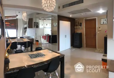 Spacious modern apartment interior with open-plan kitchen, elegant dining area, and chic lighting fixtures, perfect for urban living.