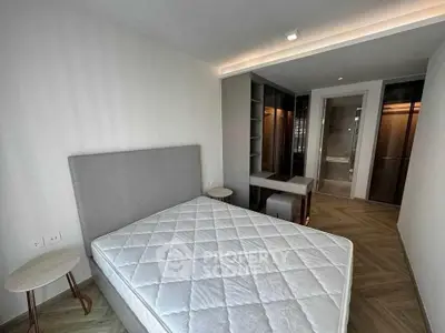 Modern bedroom with stylish furniture and walk-in closet