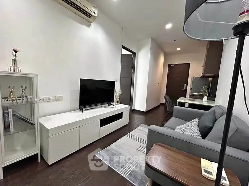 Modern living room with sleek furniture and stylish decor in a contemporary apartment.