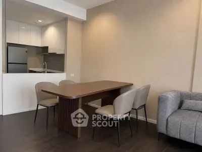 Modern living room with dining area and open kitchen in a stylish apartment.
