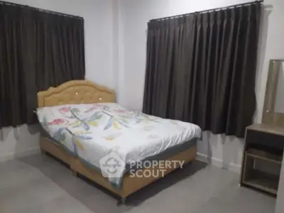 Cozy bedroom with elegant curtains and stylish bed in modern home.