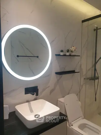 Modern bathroom with illuminated mirror and sleek fixtures