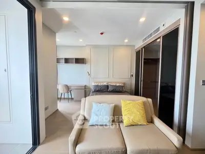 Modern studio apartment with cozy living area and stylish bedroom setup.