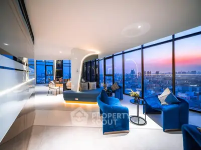 Luxurious modern living room with panoramic city view and elegant blue seating