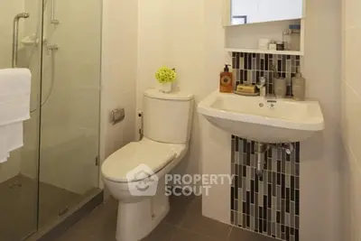 Modern bathroom with sleek fixtures and stylish tile accents.
