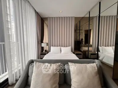 Luxurious bedroom with modern decor and floor-to-ceiling windows in a high-end apartment.