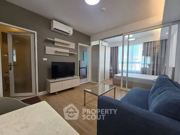 Modern living room with sleek furniture and open layout in a stylish apartment.