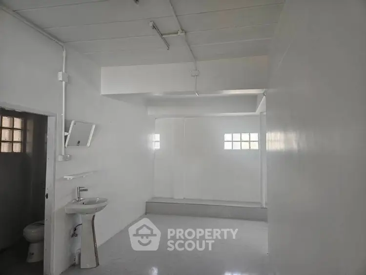 Spacious minimalist bathroom with white walls and modern fixtures