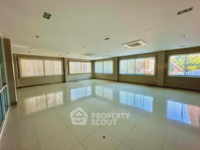 Spacious office space with large windows and tiled flooring, ideal for business setup.