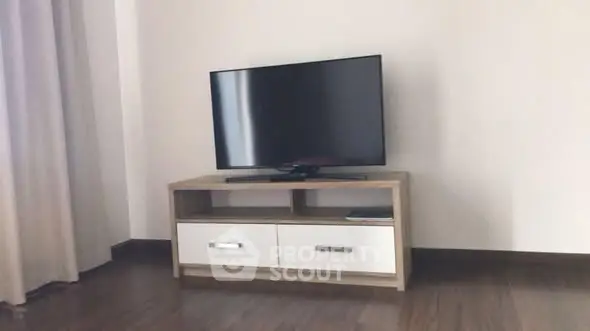 Modern living room with sleek TV stand and flat-screen television