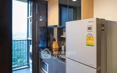 Modern kitchen with balcony view, featuring sleek appliances and stylish cabinetry.