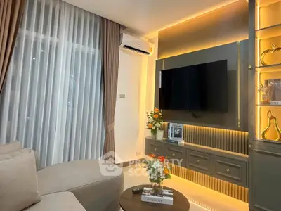 Modern living room with elegant decor, featuring a wall-mounted TV, ambient lighting, and stylish furniture.