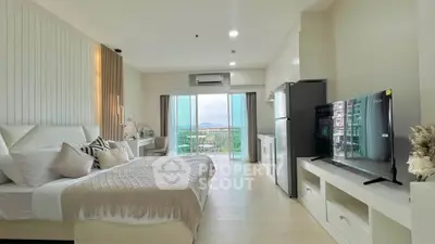 Modern studio apartment with stylish decor and balcony view