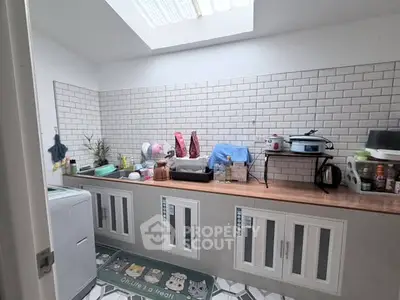 Charming kitchen with skylight and modern cabinetry, perfect for culinary enthusiasts.