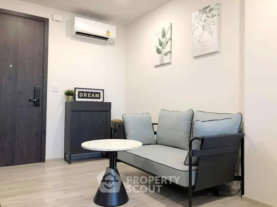 Modern living room with stylish sofa and wall art in a cozy apartment.