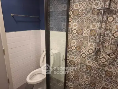 Stylish bathroom with patterned tiles and modern shower