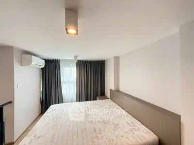 Spacious bedroom with large window and modern air conditioning unit