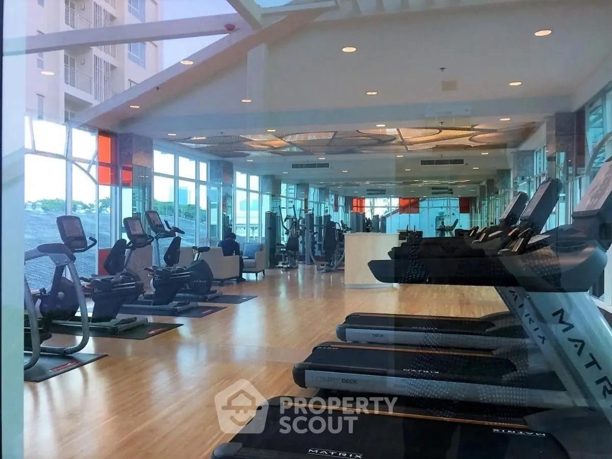 Spacious modern gym with state-of-the-art equipment and panoramic windows.