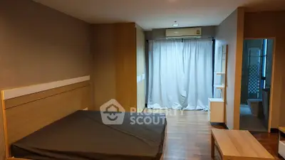 Spacious bedroom with modern design and wooden flooring