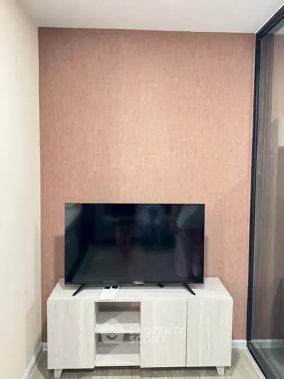 Modern living room with sleek TV setup and stylish wooden cabinet