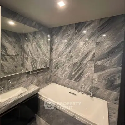 Luxurious marble bathroom with elegant bathtub and modern fixtures