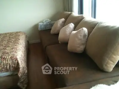 Cozy bedroom with plush sofa and elegant bedding, perfect for relaxation and comfort.