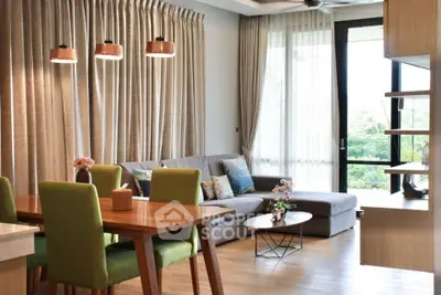 Modern living room with stylish decor and large windows offering natural light.