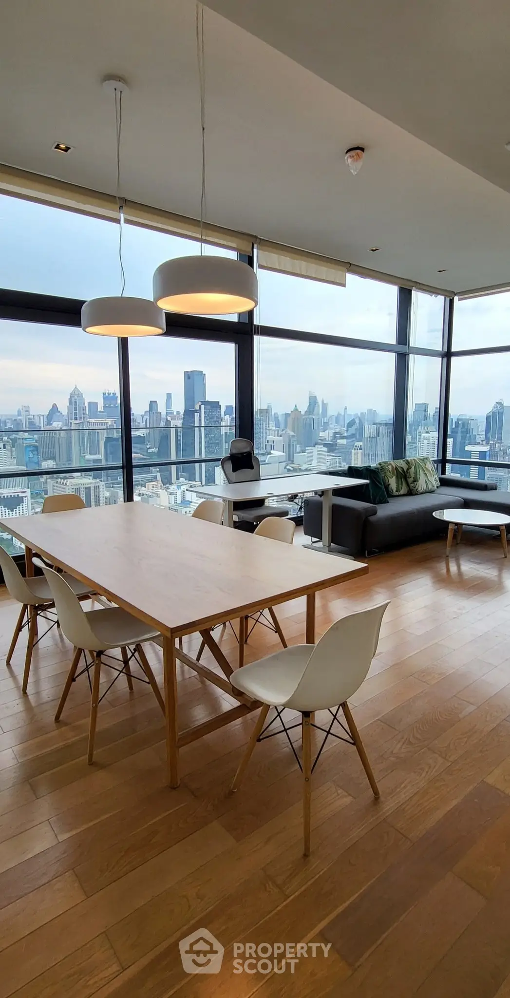 Stunning modern living room with panoramic city views and elegant furnishings.