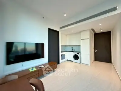 Modern living room with sleek kitchen and built-in appliances