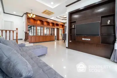 Spacious living room with modern decor and large TV unit