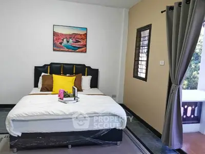 Cozy bedroom with modern decor and large window for natural light