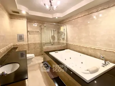 Luxurious bathroom with jacuzzi tub and elegant marble finishes